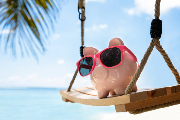 piggy bank swinging on beach